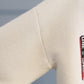 Turtleneck sweater letter holes