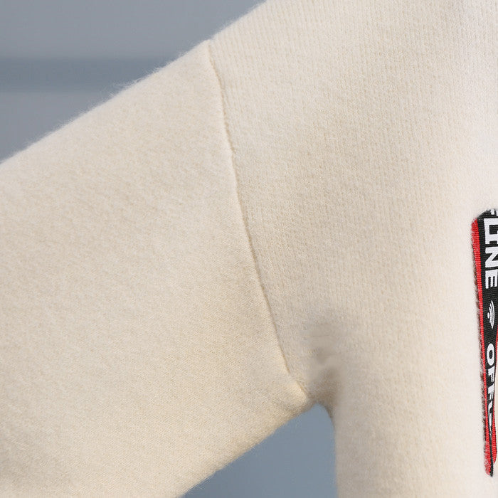 Turtleneck sweater letter holes