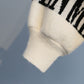 Turtleneck sweater letter holes