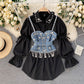Ensemble deux pièces chemise à manches bouffantes et haut à pompons et perles