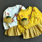 Ensemble pull brodé et jupe à carreaux