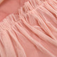 Jupe mi-longue à lacets et pompons tendance, manches chauve-souris, col en V